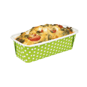 Green polka-dotted baking dish filled with a cheesy baked casserole topped with seeds and vegetables.