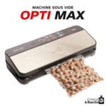 Sous-vide vacuum sealer in action with a sealing bag of brown nuts (hazelnuts) emerging from the machine, branding OPTI MAX and Cuisine & Basilic visible at corners.