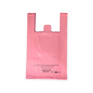 Pink plastic shopping bag with two long handles hanging upright against a white background, empty inside.