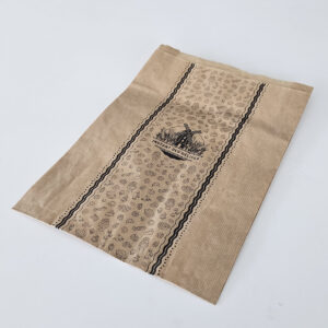 Brown paper bag with black decorative stripes and a windmill logo with the text INSTANT DES DELICES.