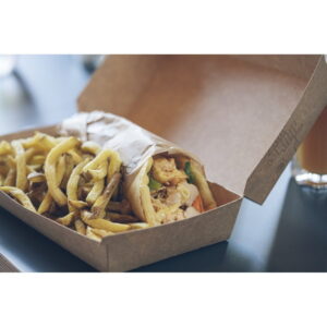 Takeout box with a chicken wrap and a generous portion of French fries on a dark table jn